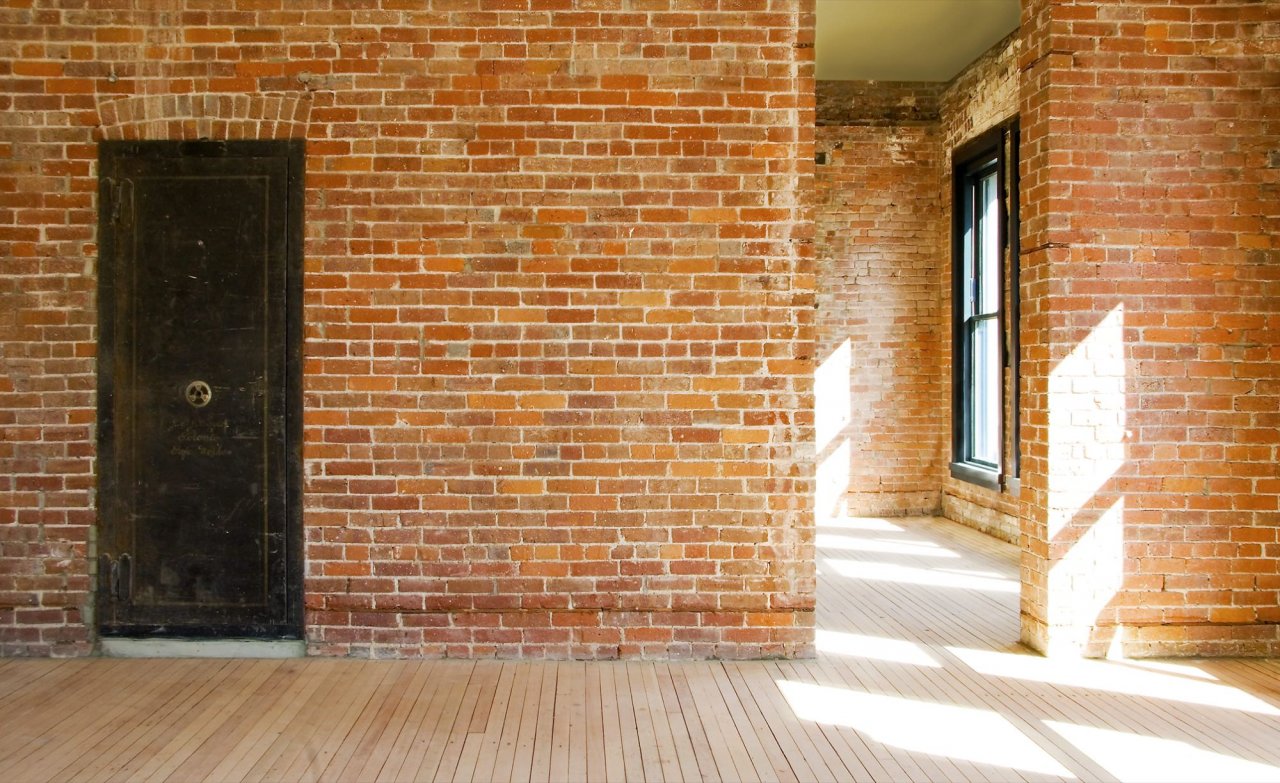 exposed brick walls and timber laminated floor.